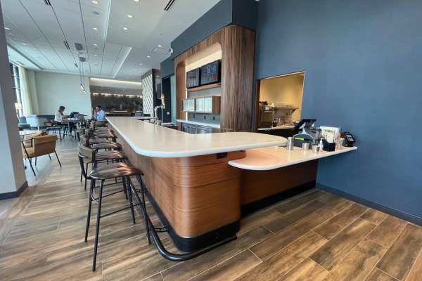 Retro-modern furniture and classic decor in a model home's living area at Outfield Ball Park Lofts in Lansing, Michigan