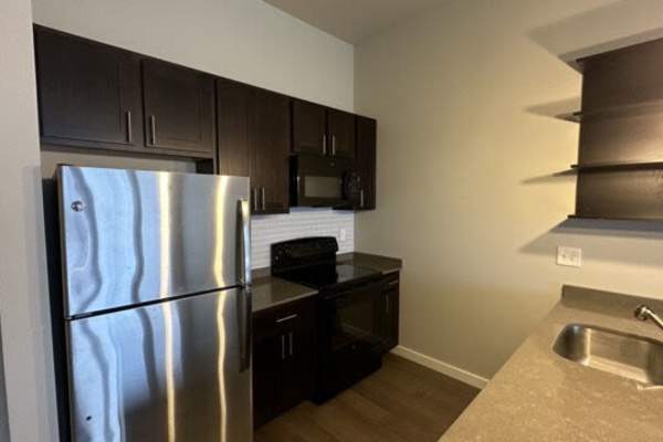 Retro-modern furniture and classic decor in a model home's living area at Outfield Ball Park Lofts in Lansing, Michigan