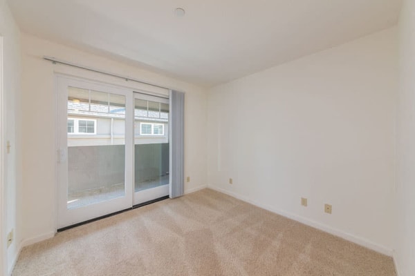 Comfortable living room with sliding glass door at Clay Street Residences in Santa Cruz, California
