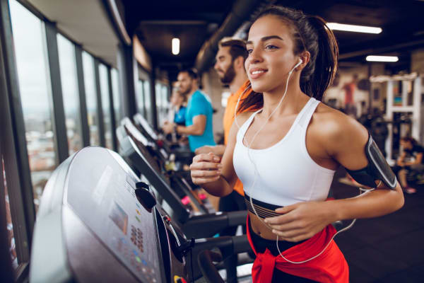 Resident running on treadmill in the fitness center at Hidden Creek in Vacaville, California