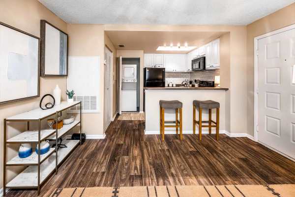 Model apartment interior with wood-style flooring at The Meridian in Jacksonville, Florida