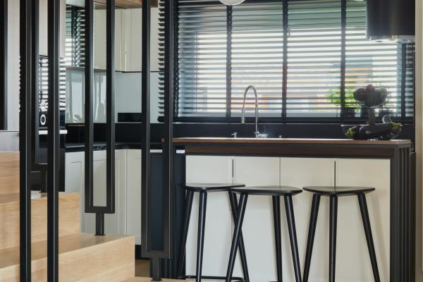 Retro-modern furniture and classic decor in a model home's living area at Outfield Ball Park Lofts in Lansing, Michigan