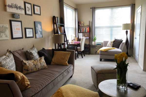 Retro-modern furniture and classic decor in a model home's living area at Beaumont in East Lansing, Michigan