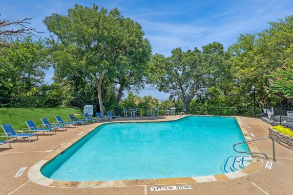 Lounge seating beside the community swimming pool at Verandahs at Cliffside Apartments in Arlington, Texas