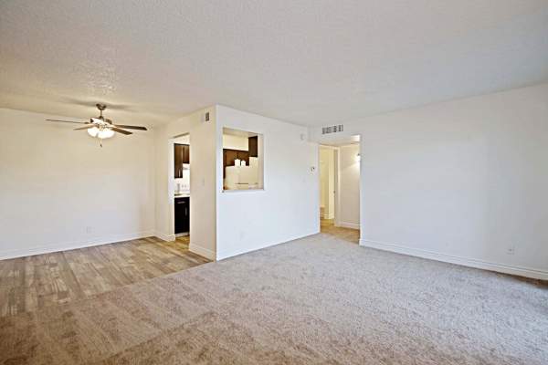 Empty apartment layout with wood-style flooring and a ceiling fan at 544 Southern Apartments in Mesa,Arizona