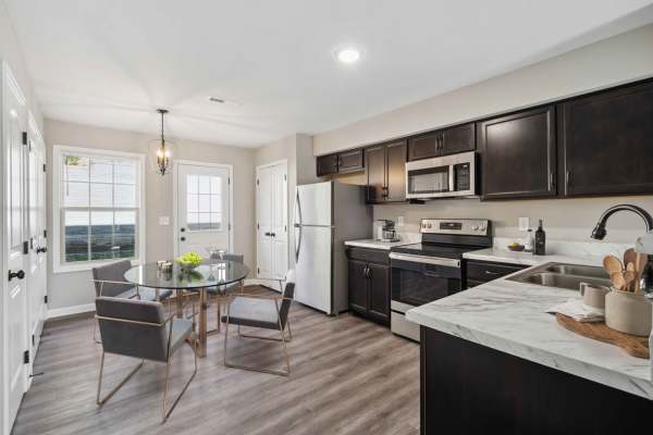 Fully-equipped kitchen with all stainless appliances including dishwasher, microwave at Center Pointe Townhomes in Clarksville,Tennessee
