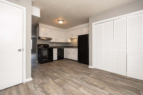 Kitchen with granite countertop, stainless steel sink, refrigerator, stove, dishwasher and oven at Golf View Apartments in Clarksville, Tennessee