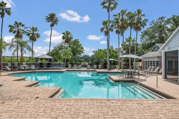 Resort-style swimming pool with multiple lounge chairs at Rosemont Windermere in Orlando, Florida