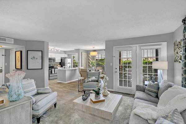 Living room with a couch and attached kitchen and dining area at Rosemont Windermere in Orlando, Florida