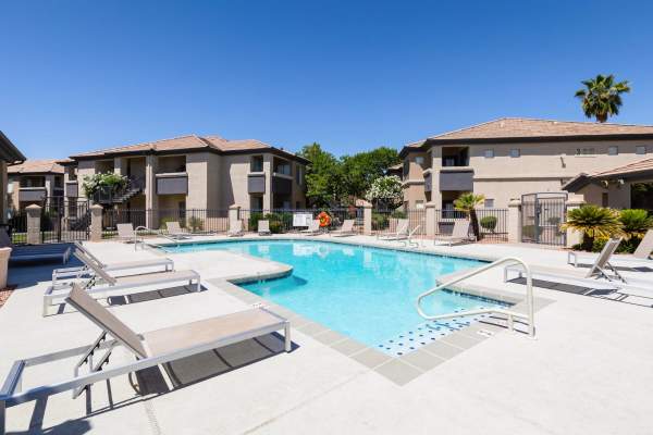 Resident dipping her toes in the pool at Sol District in Phoenix, Arizona
