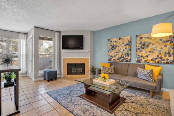 Living room with a television and a table at The Canopy Apartment Villas in Orlando, Florida