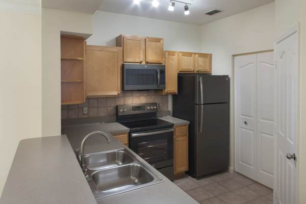 Kitchen with granite countertop at The Legends At ChampionsGate in ChampionsGate, Florida
