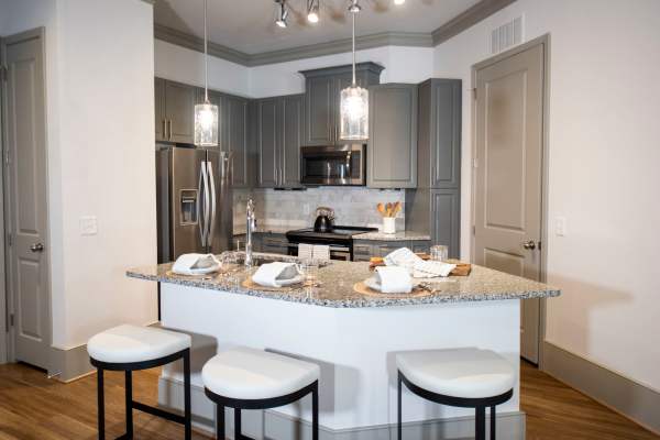 Luxurious kitchen and living room in a model home at The Mill at Westside in Atlanta, Georgia