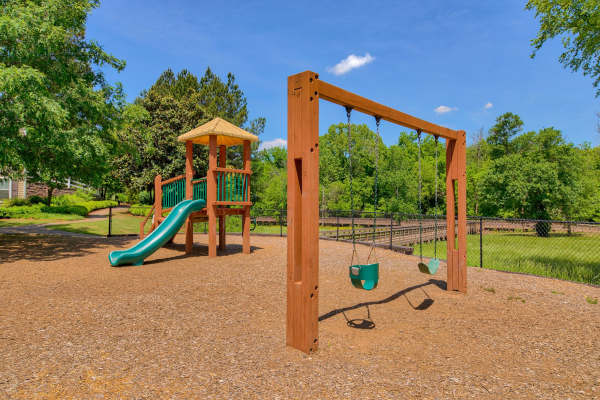 Resident giving his wife a kiss on the cheek in their new home's kitchen at Avonlea Towne Lake in Woodstock, Georgia     
