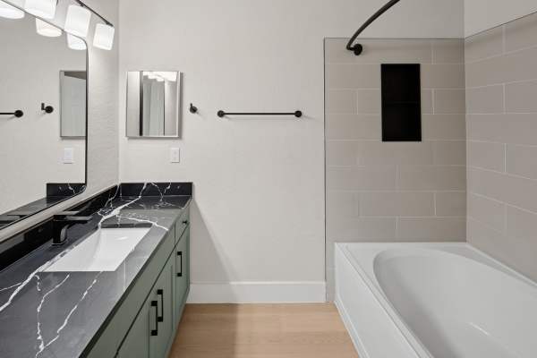 Spacious bathroom with double storage vanity and bathtub at Dawson in Orlando, Florida 