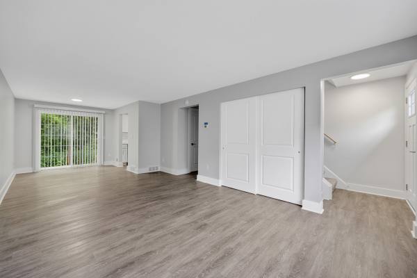 Unfurnished living room with wooden flooring at Valley Brook Townhomes in Rochester, New York