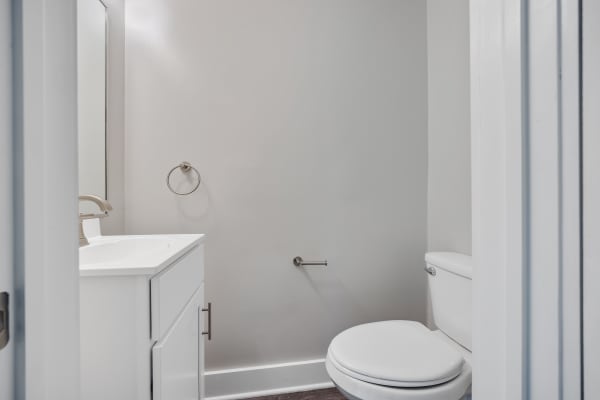Bathroom with wooden flooring at Valley Brook Townhomes in Rochester, New York