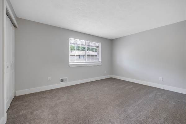 Bedroom carpet flooring at Valley Brook Townhomes in Rochester, New York