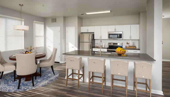 White spec kitchen cabinetry with stainless steel appliances and kitchen island at The Rail at Inverness in Englewood