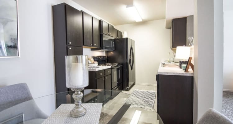 A kitchen and dining room in a model apartment at Legacy Trail in Norman, Oklahoma