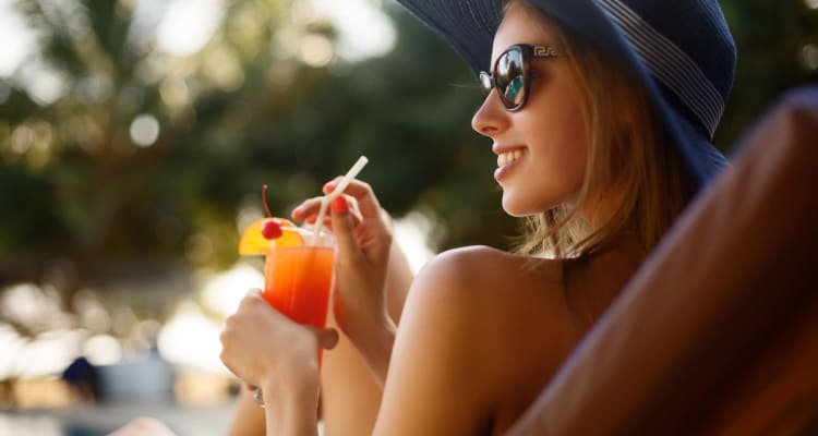 Resident lounging by the pool at Tavalo at Cadence in Mesa, Arizona