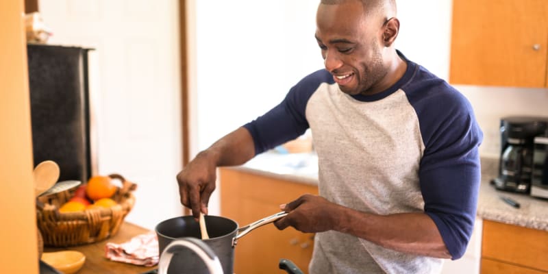 A man preparing a meal at River Place in Lakeside, California