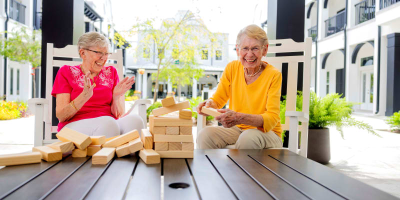 Two beautiful ladies playing jenga at The Blake at Kingsport in Kingsport, Tennessee