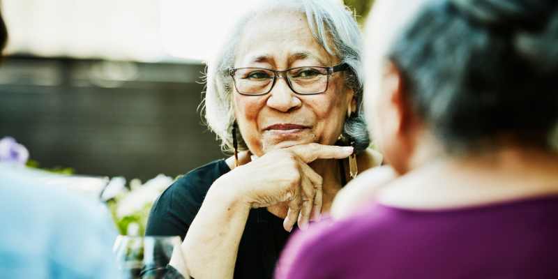 Residents sitting outside having a meal together at a The Barclay at ParkSquare community