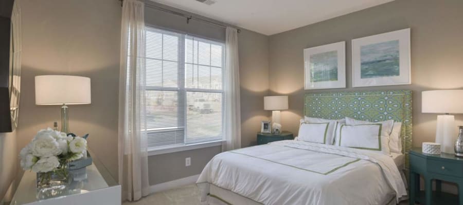 Model bedroom with large windows at Avanti Luxury Apartments in Bel Air, Maryland