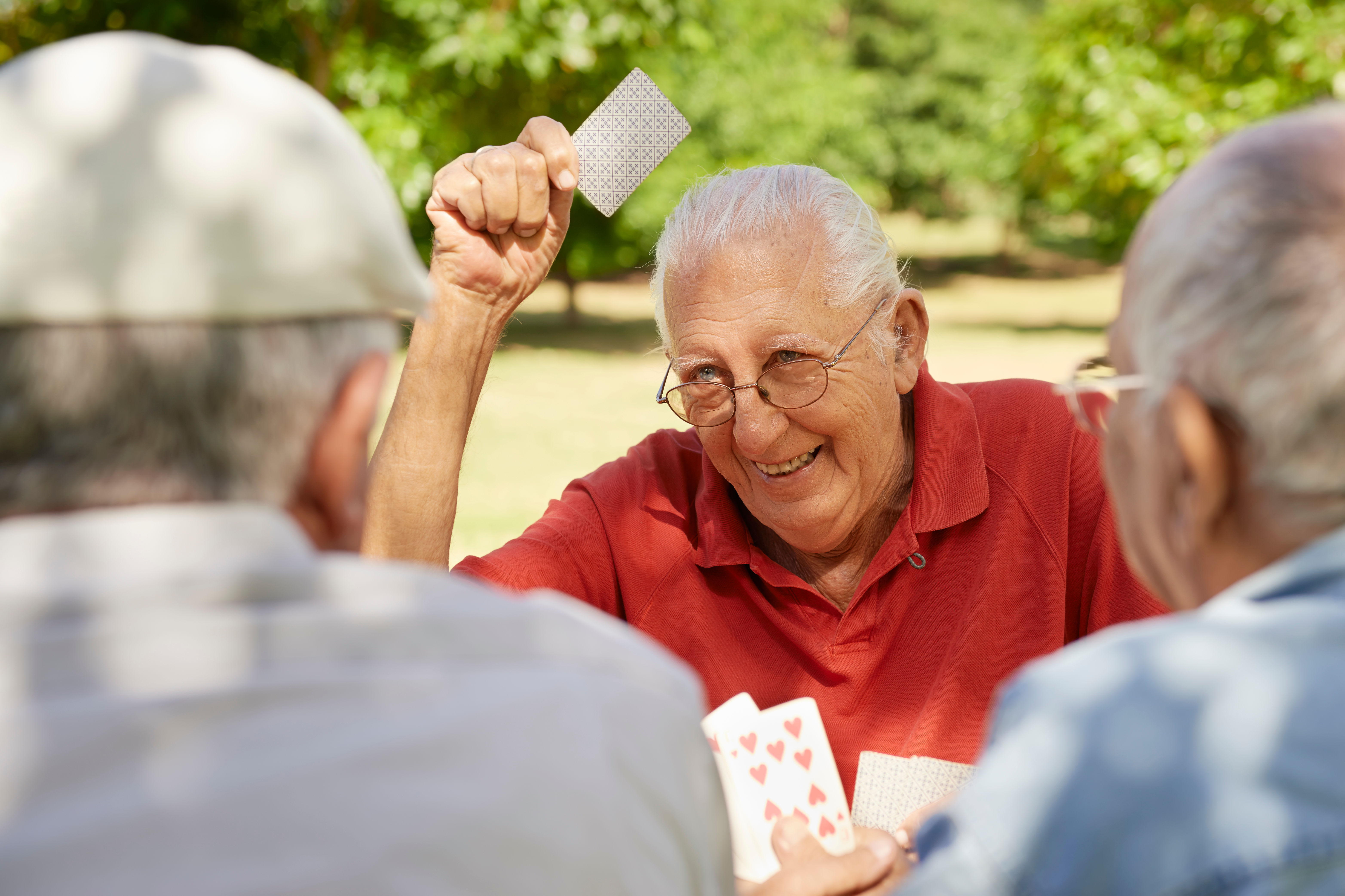 Residents playing a card game at The Iris Senior Living in Great Falls, Montana