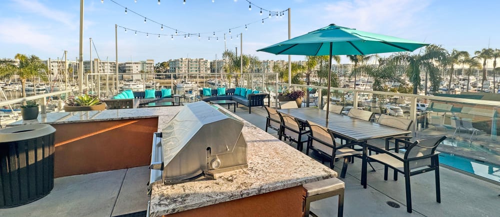 A barbecue and seating on the sundeck at Harborside Marina Bay Apartments in Marina del Rey, California