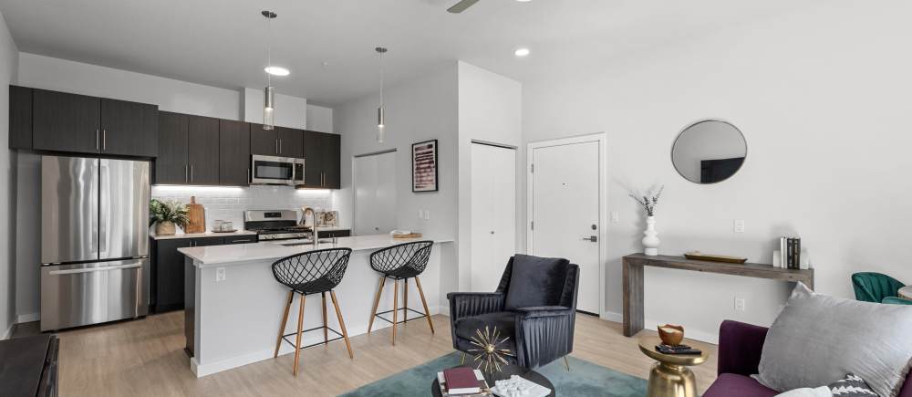 Spacious living room and model kitchen at The Highlands at Silverdale in Silverdale, Washington