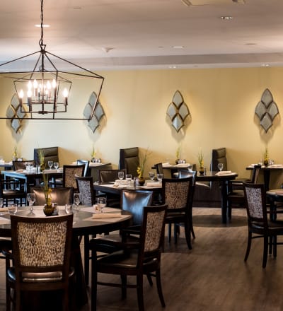 Tables set in the dining room at Keystone Place at Naples Preserve in Naples, Florida