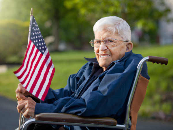 A veteran holding a flag at Patriots Landing in DuPont, Washington. 