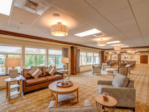 Spacious lounge with big windows at Mission Healthcare at Renton in Renton, Washington. 