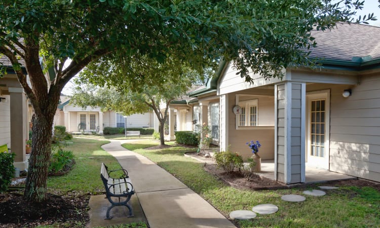 Apartment home patios and beautiful landscaping and walkways at Carriage Inn Huntsville in Huntsville, Texas