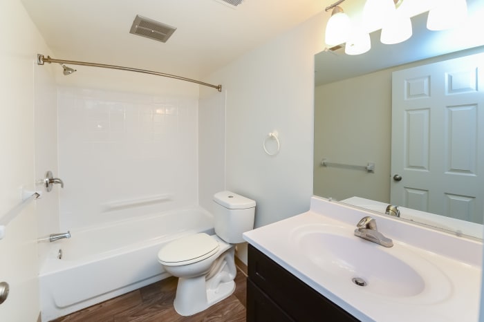Bathroom with wood-style flooring and a shower/tub combination at Forge Gate Apartment Homes in Lansdale, Pennsylvania