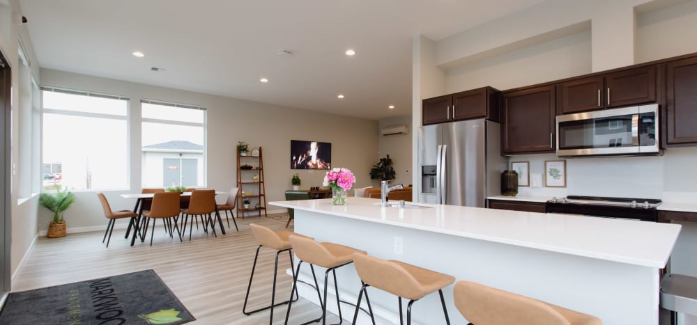 Community room with chefs kitchen and entertainment space at Markwood Apartments in Burlington, Washington