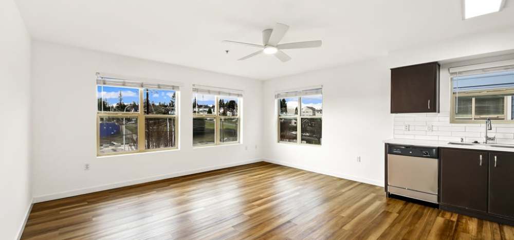 View of spacious living room from kitchen at Lumen in Everett, Washington, 