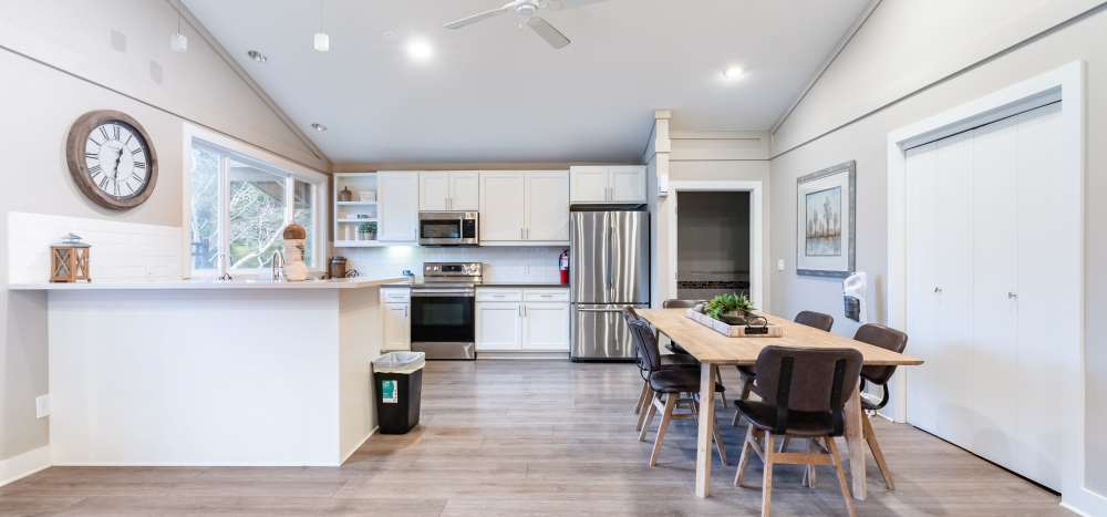 Modern kitchen with dining area at The Courtyard Apartment Homes in Mukilteo, Washington