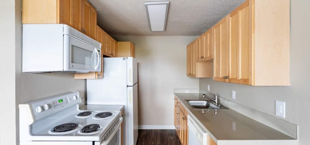 Kitchens with extra cabinets and storage space at The Courtyard Apartment Homes in Mukilteo, Washington