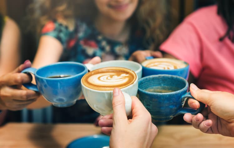 Friends having coffee together near Five Points in Auburn Hills, Michigan