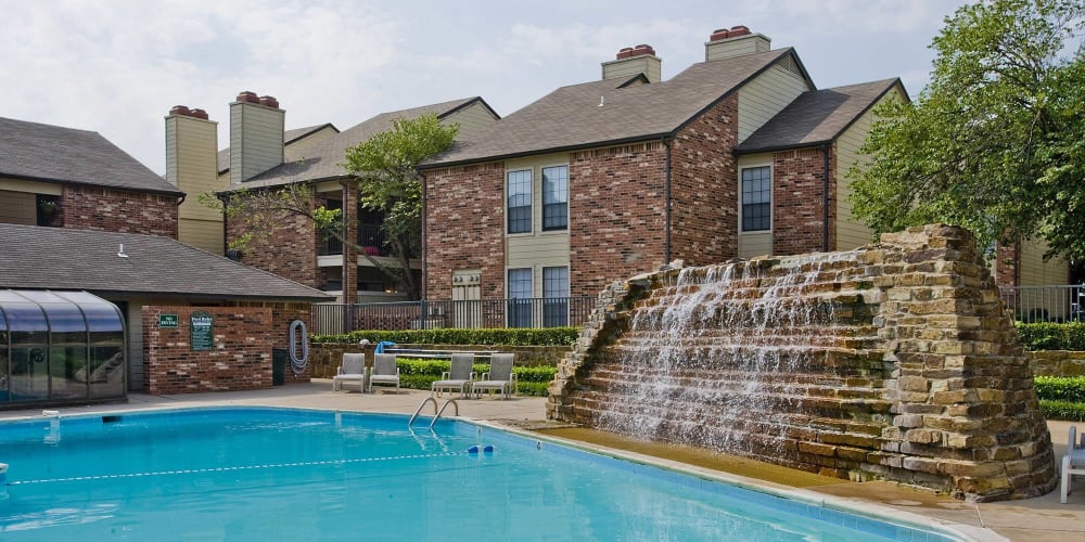 A waterfall by the pool at The Warrington Apartments in Oklahoma City, OK