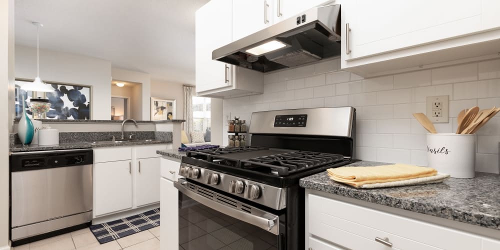 Modern kitchen with a subway tile backsplash and stainless-steel appliances in a model home at 200 East in Durham, North Carolina