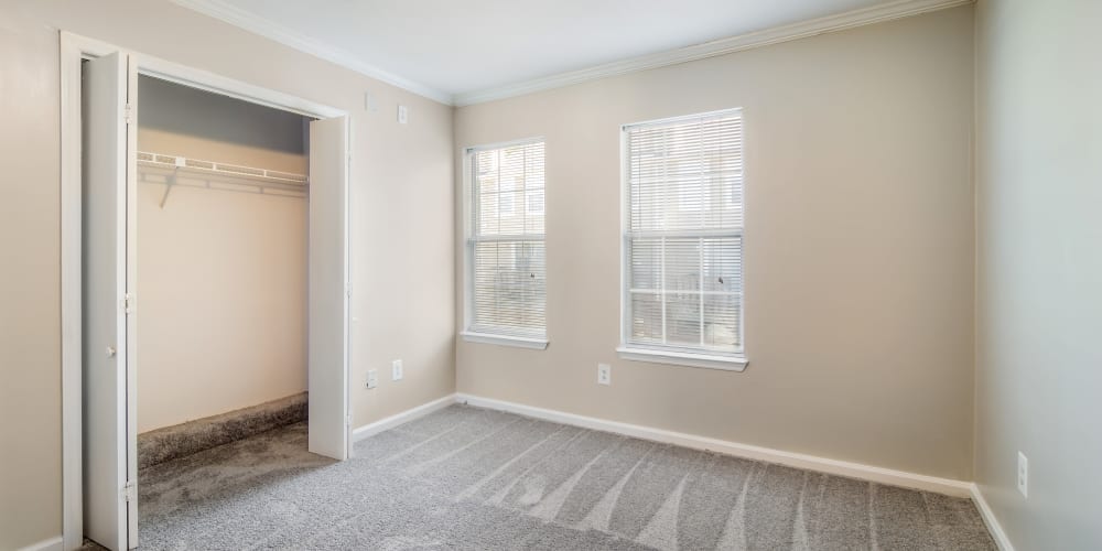 Spacious bedroom with two windows and a closet at 220 West Townhomes in Augusta, Georgia