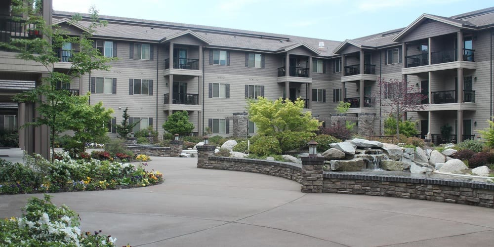 Inviting courtyard with a pond and lots of foliage at The Springs at Veranda Park in Medford, Oregon