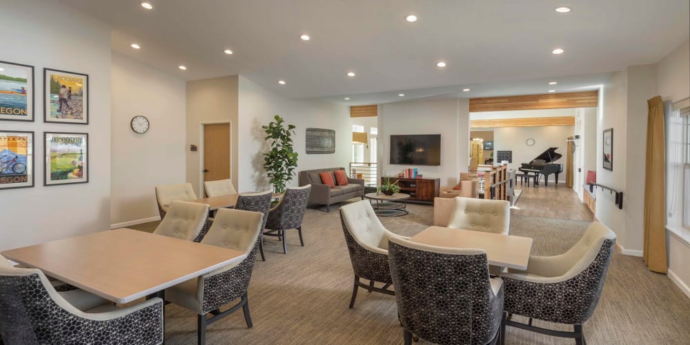 Relaxing lounge with comfy chairs and coffee tables perfect for card games at The Springs at Clackamas Woods in Milwaukie, Oregon