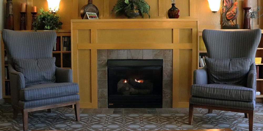 Comfy puzzle room complete with arm chairs and fireplace at The Springs at Sunnyview in Salem, Oregon