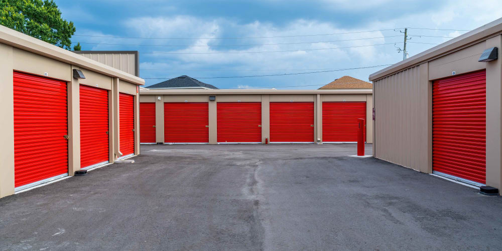 Outdoor storage units with red doors at StorQuest Express Self Service Storage in Copperopolis, California