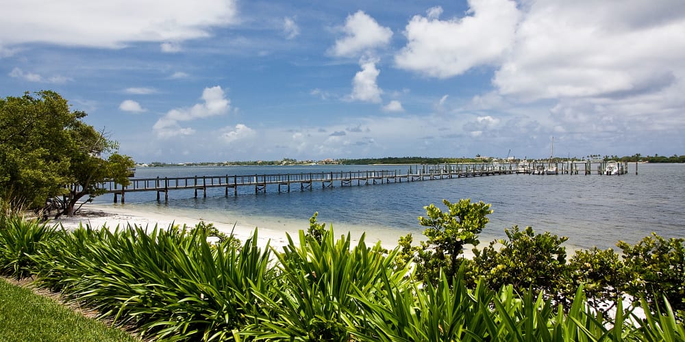 View of the beach and pier at Manatee Bay Apartments in Boynton Beach, Florida